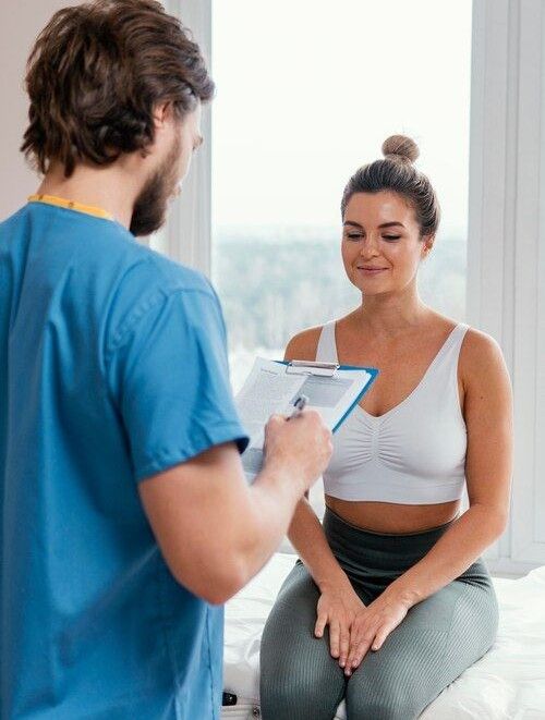 A clinician reviewing health history with a patient